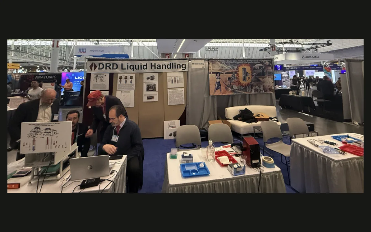 The DRD Liquid Handling booth at a trade show, with the DRD and Envion teams at the tables